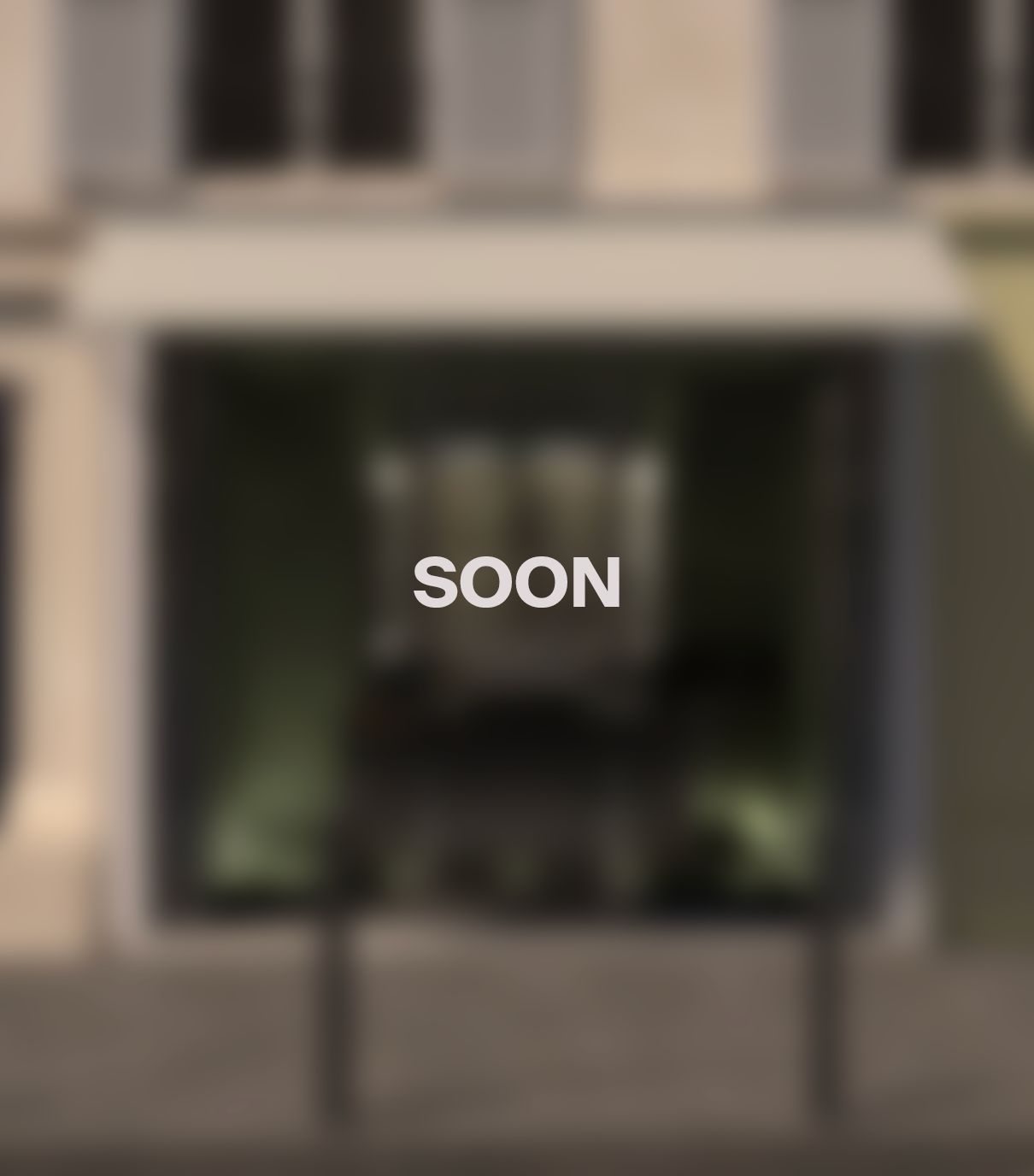 A blurred exterior view of WHITE Coffee - Paris 4, showcasing its café atmosphere and stylish entrance.