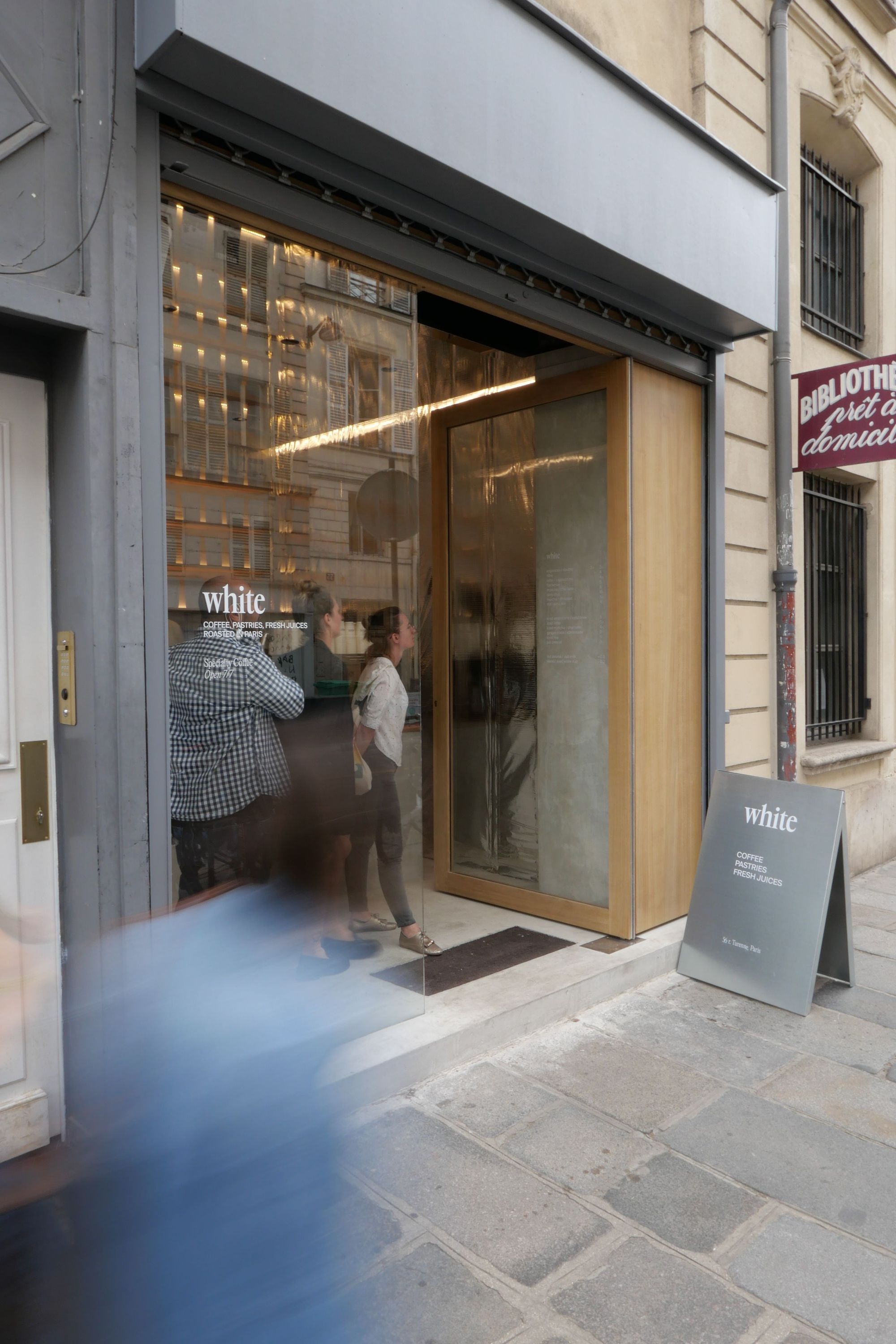 Entrée du café WHITE Coffee à Paris, un lieu réputé parmi les meilleurs coffee shops.